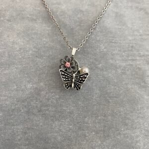 Silver butterfly necklace with flower and faux pearl detail